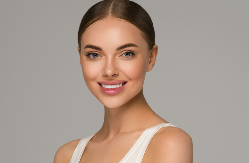 A woman with bright white teeth smiling at the camera