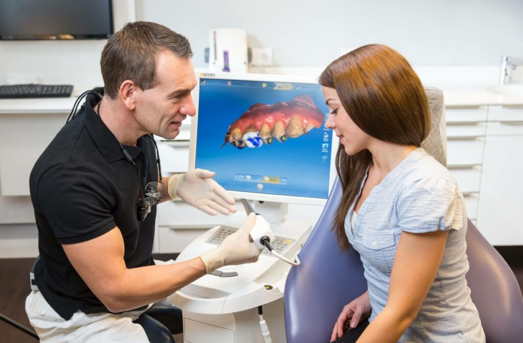 Dentist discussing a same-day CEREC dental crown with a patient using digital imaging technology on a computer screen