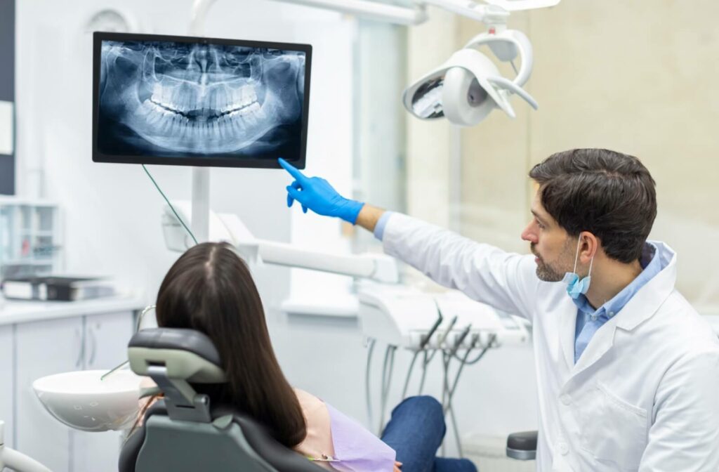 A dentist carefully reviews a patient’s X-ray to pinpoint the underlying cause of their TMJ disorder.