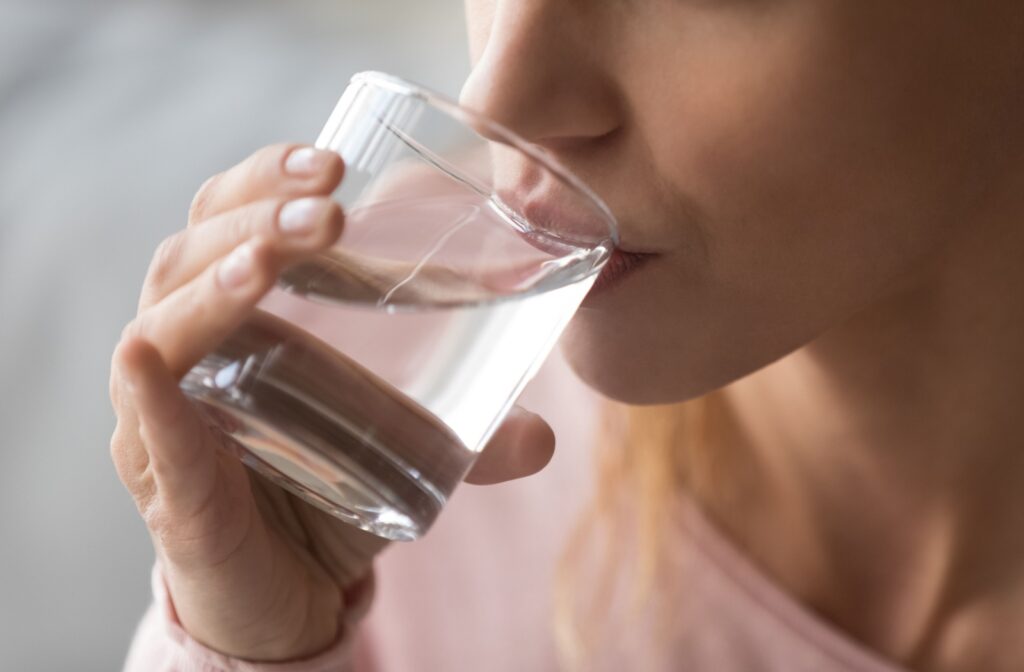 Close-up of a woman rinsing her mouth with saltwater.