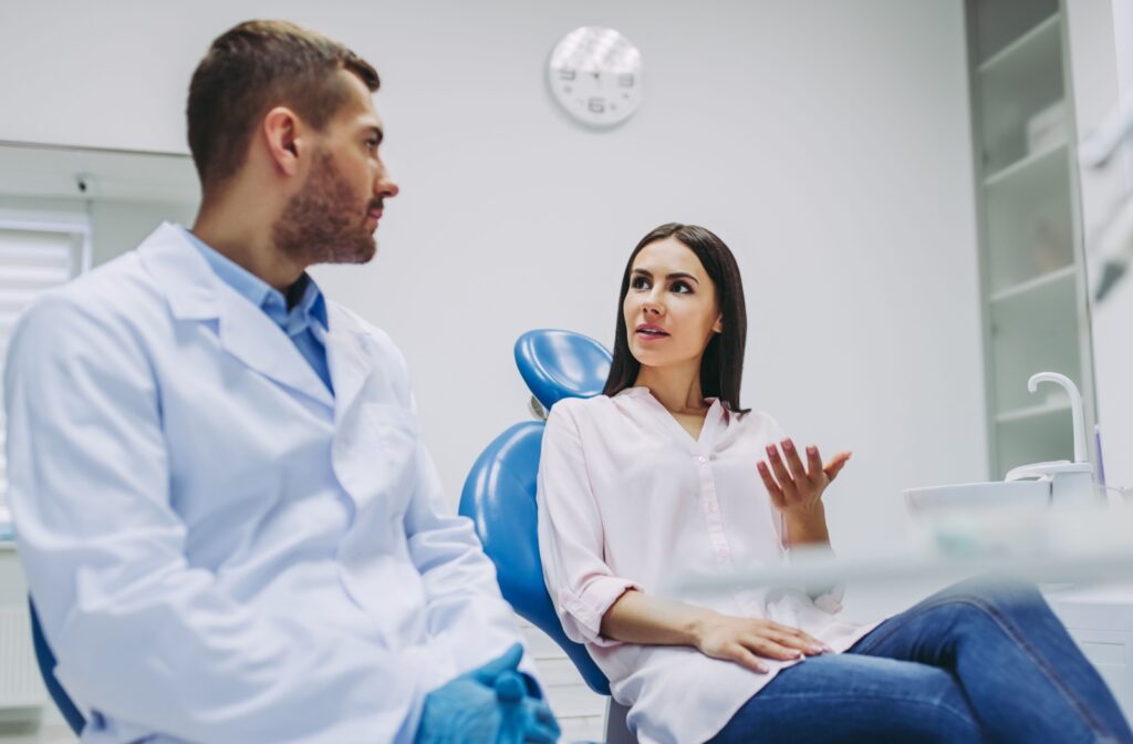 A person discussing treatment options with a dentist